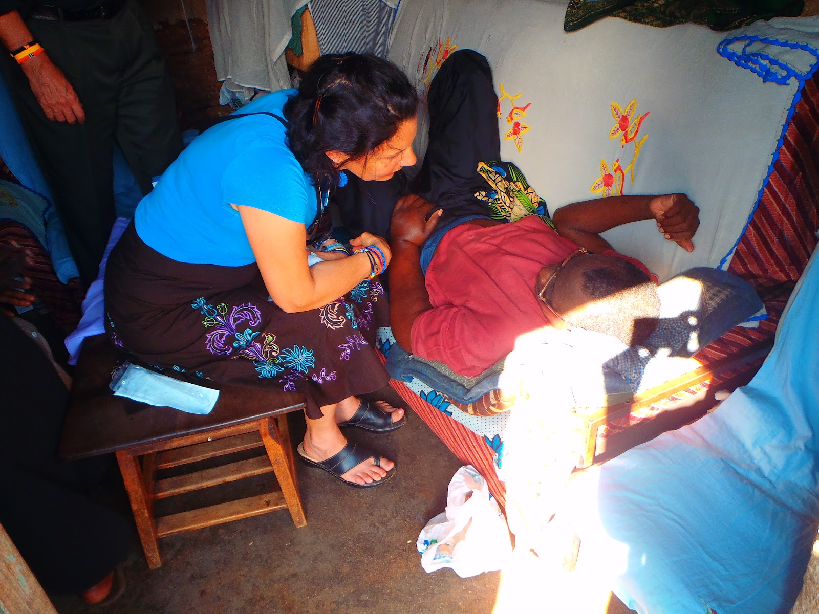 Pam speaking to John and getting ready to clean his wound.